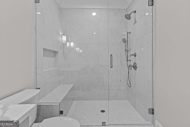 full bathroom featuring a stall shower and toilet