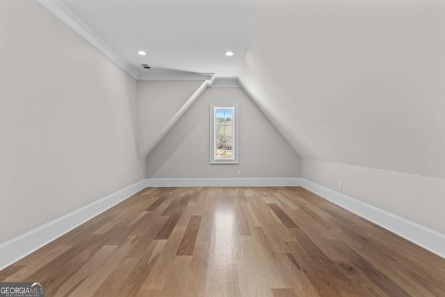 bonus room with lofted ceiling, recessed lighting, baseboards, visible vents, and wood finished floors