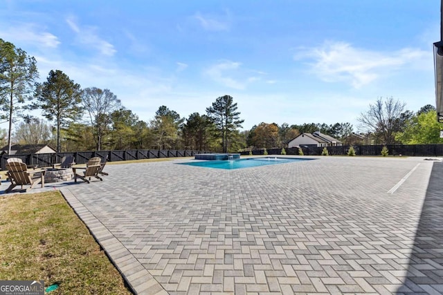 view of swimming pool featuring a patio, a fire pit, fence, and a fenced in pool