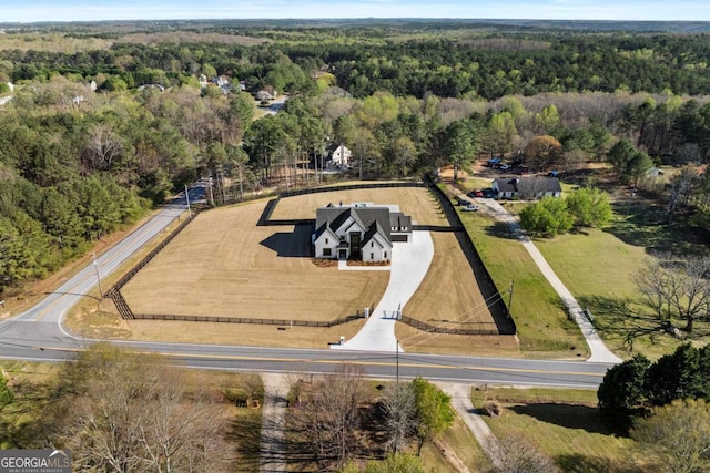 drone / aerial view featuring a wooded view and a rural view