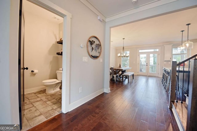 1494 Addison Pl, Decatur, GA 30033 - corridor with crown molding, baseboards, stairway, a chandelier, and dark wood finished floors