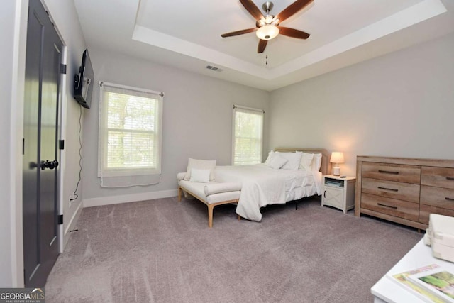 1494 Addison Pl, Decatur, GA 30033 - carpeted bedroom with multiple windows, a tray ceiling, baseboards, and a ceiling fan