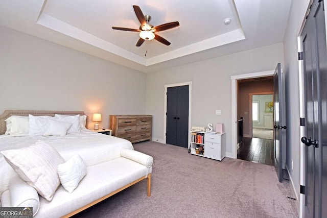 1494 Addison Pl, Decatur, GA 30033 - carpeted bedroom featuring a tray ceiling, ceiling fan, and baseboards