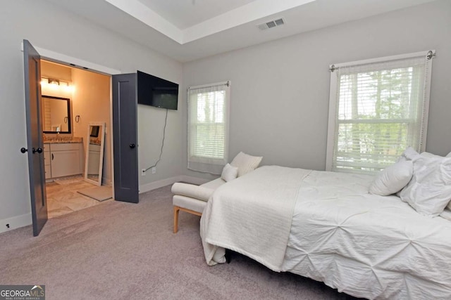 1494 Addison Pl, Decatur, GA 30033 - bedroom featuring light colored carpet, ensuite bath, and baseboards
