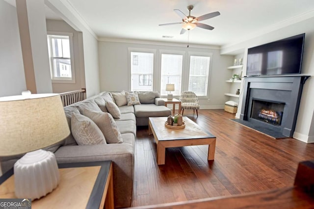 1494 Addison Pl, Decatur, GA 30033 - living room with ceiling fan, healthy amount of natural light, wood finished floors, a fireplace with flush hearth, and ornamental molding