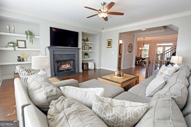 1494 Addison Pl, Decatur, GA 30033 - living area with ornamental molding, baseboards, built in features, a ceiling fan, and a fireplace with flush hearth