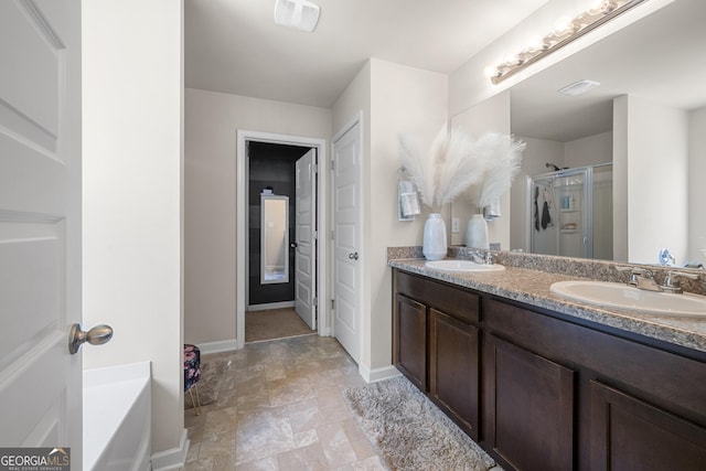 bathroom with visible vents, a sink, a shower stall, and double vanity
