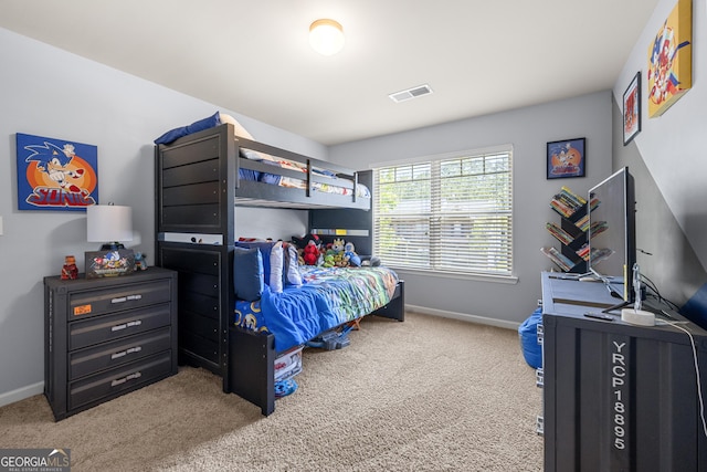 bedroom with baseboards, visible vents, and carpet