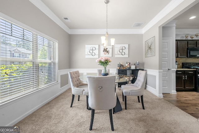 dining space featuring an inviting chandelier, ornamental molding, and visible vents