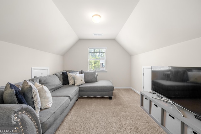 living room with baseboards, lofted ceiling, visible vents, and light colored carpet