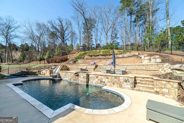 view of pool featuring a patio, fence, and a fenced in pool