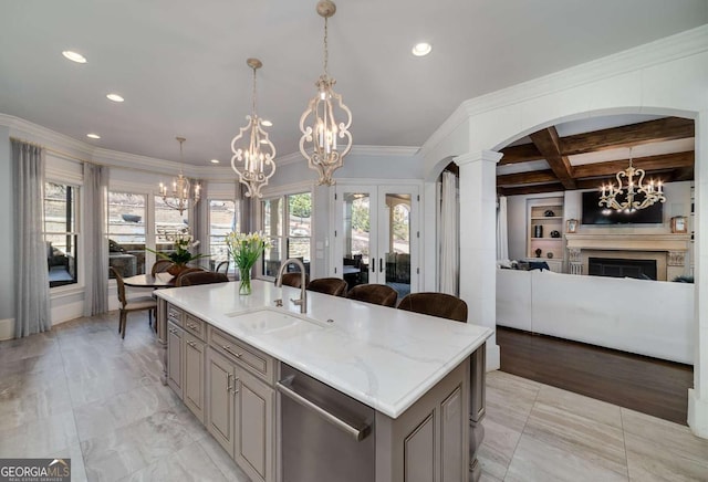 kitchen featuring open floor plan, recessed lighting, a chandelier, a sink, and dishwasher