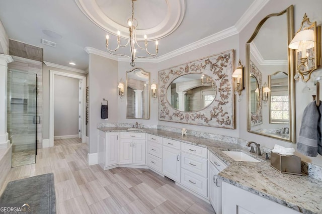 bathroom with a sink, a stall shower, a chandelier, and ornamental molding