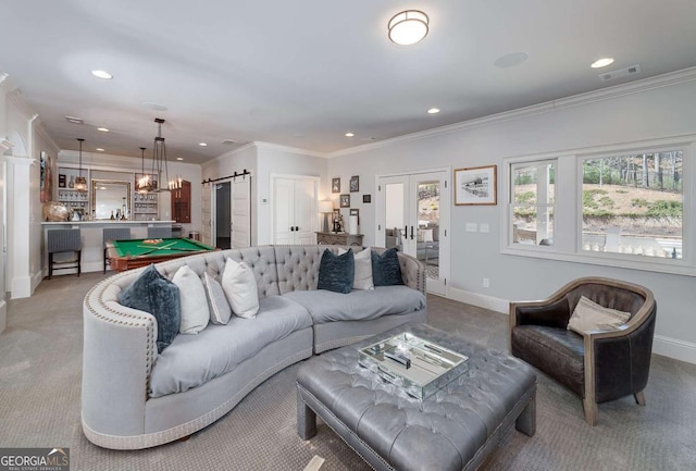 living area featuring light colored carpet, a barn door, and recessed lighting