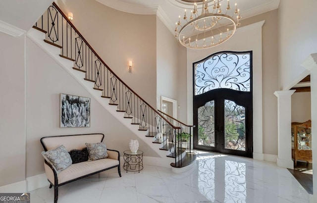entrance foyer featuring french doors, stairway, ornamental molding, marble finish floor, and a high ceiling