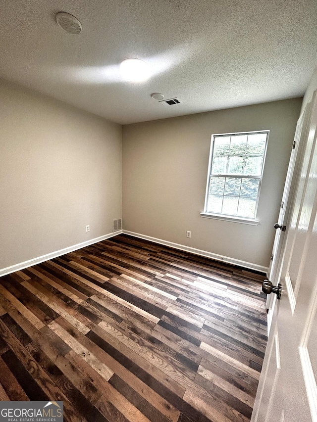 1864 Drew Cir, Austell, GA 30168 - empty room with dark wood-style floors and a textured ceiling