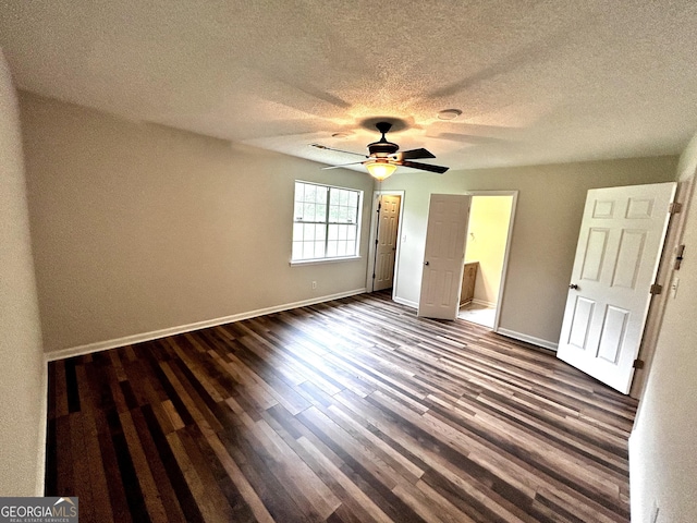 1864 Drew Cir, Austell, GA 30168 - unfurnished bedroom featuring dark wood-style floors, a textured ceiling, connected bathroom, and ceiling fan