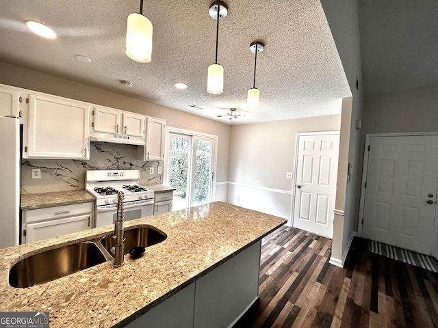 1864 Drew Cir, Austell, GA 30168 - kitchen featuring white range with gas cooktop, white cabinets, decorative light fixtures, a textured ceiling, and light stone counters