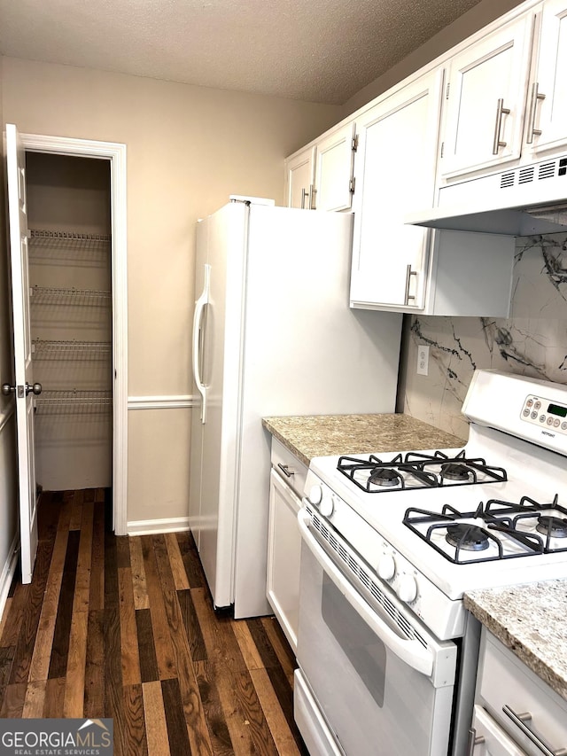 1864 Drew Cir, Austell, GA 30168 - kitchen with white range with gas cooktop, under cabinet range hood, dark wood-style flooring, tasteful backsplash, and white cabinets