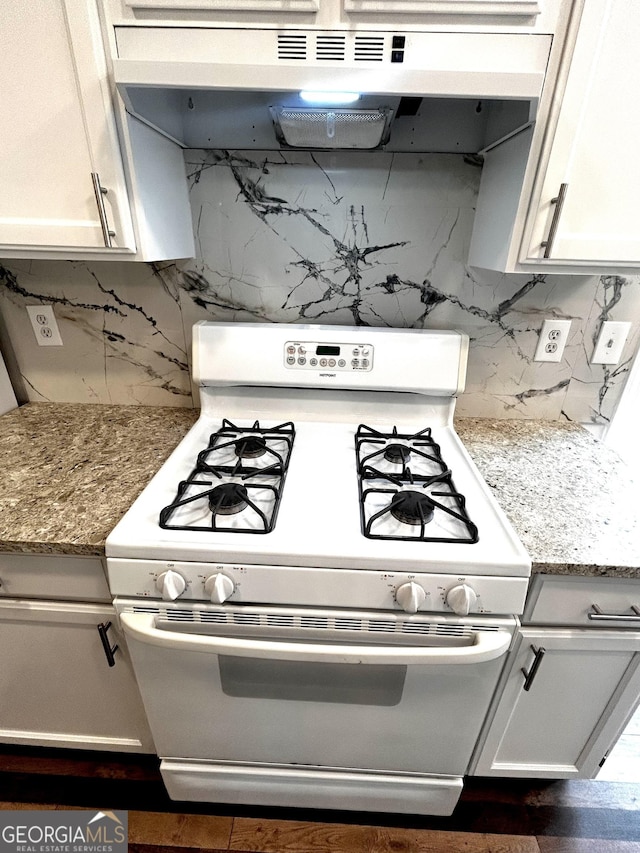 1864 Drew Cir, Austell, GA 30168 - kitchen with white range with gas stovetop, under cabinet range hood, decorative backsplash, white cabinets, and light stone countertops