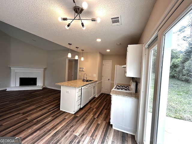 1864 Drew Cir, Austell, GA 30168 - kitchen with white appliances, a textured ceiling, white cabinets, dark wood-style floors, and hanging light fixtures