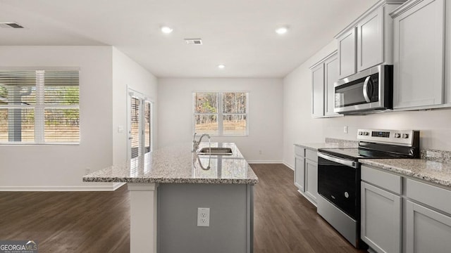 kitchen with dark wood-type flooring, visible vents, a sink, and appliances with stainless steel finishes
