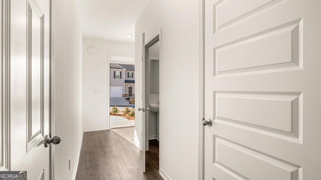 hall featuring baseboards and dark wood-style floors