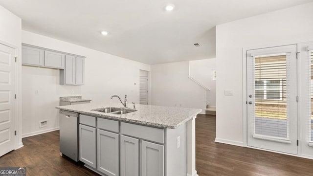 kitchen with a sink, dishwasher, gray cabinetry, and light stone countertops