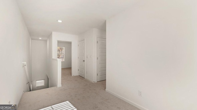 carpeted empty room with baseboards