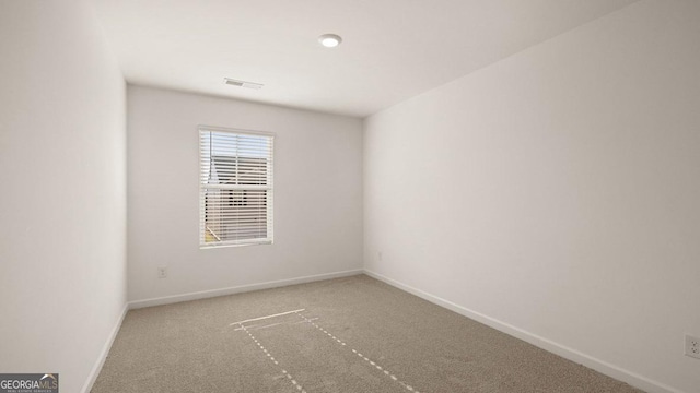 unfurnished room featuring baseboards, visible vents, and carpet floors