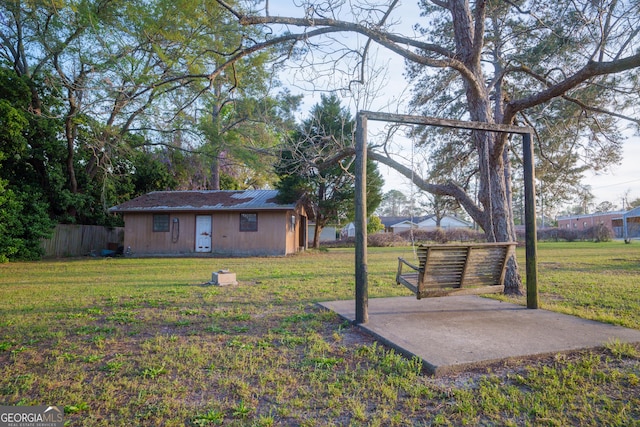view of yard with an outdoor structure, fence, and a patio
