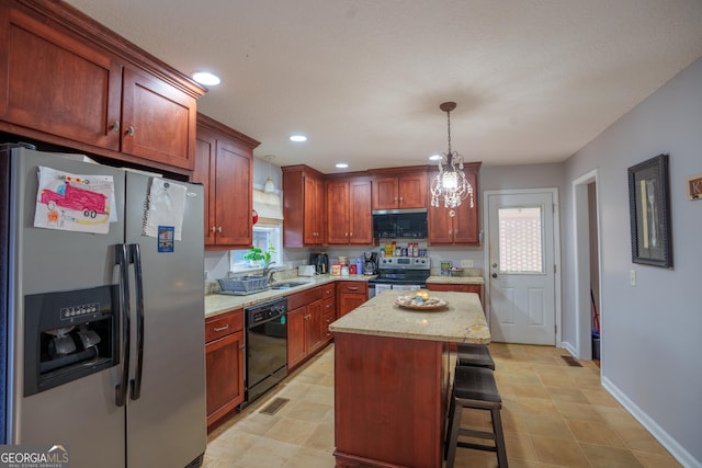kitchen featuring a sink, stainless steel appliances, decorative light fixtures, and plenty of natural light