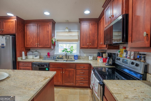 kitchen with a sink, pendant lighting, light stone countertops, and black appliances