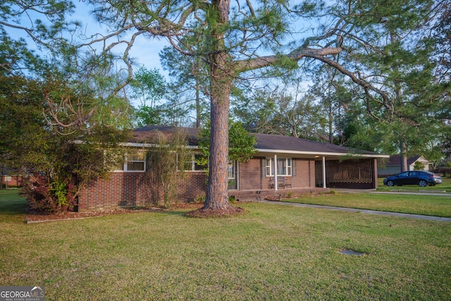 ranch-style home with an attached carport, a front yard, and brick siding
