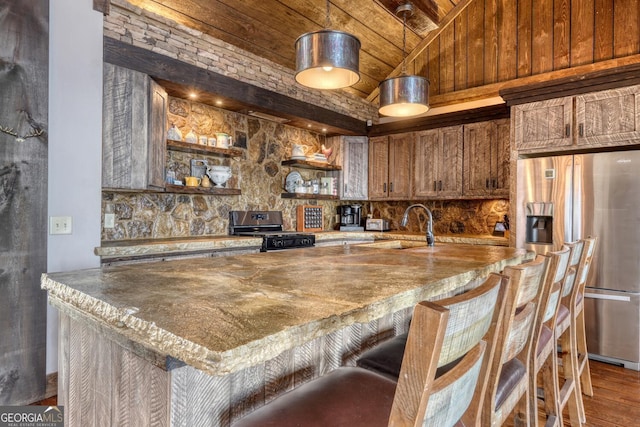 1329 Grandeur Dr, Blue Ridge, GA 30513 - kitchen featuring backsplash, open shelves, a breakfast bar area, appliances with stainless steel finishes, and lofted ceiling