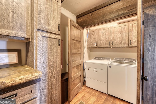 1329 Grandeur Dr, Blue Ridge, GA 30513 - laundry room featuring light wood-type flooring, washer and dryer, and cabinet space