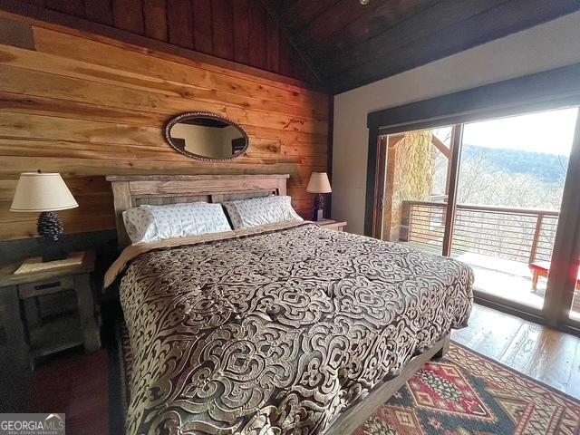 1329 Grandeur Dr, Blue Ridge, GA 30513 - bedroom featuring access to outside, wooden walls, lofted ceiling, and wood finished floors