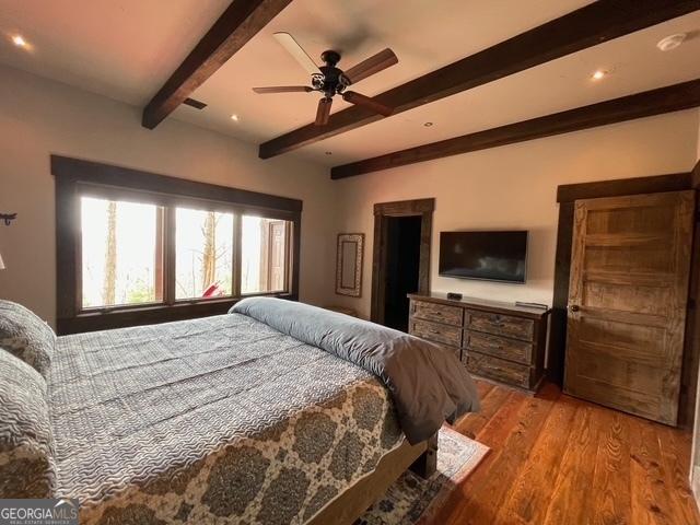 1329 Grandeur Dr, Blue Ridge, GA 30513 - bedroom featuring visible vents, beamed ceiling, ceiling fan, and wood finished floors