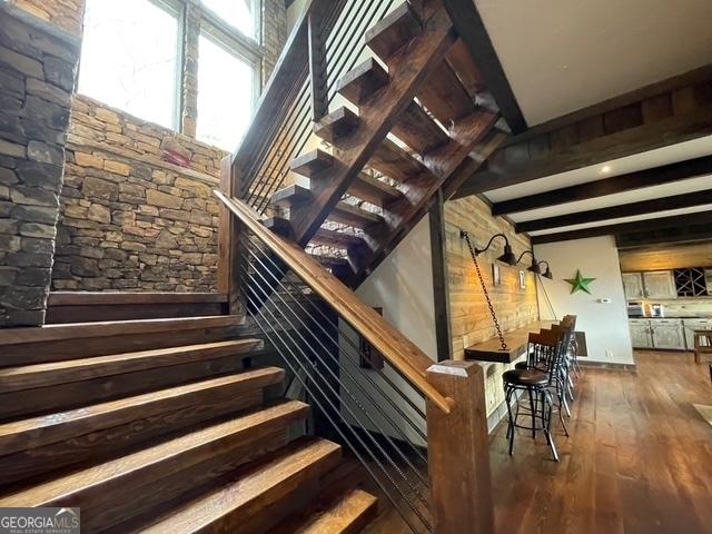 1329 Grandeur Dr, Blue Ridge, GA 30513 - staircase featuring beamed ceiling and wood finished floors
