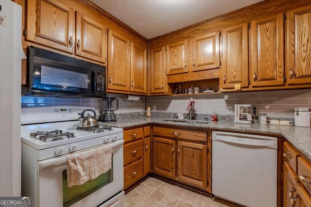 254 E Girard Ave, Cedartown, GA 30125 - kitchen featuring white appliances, brown cabinetry, decorative backsplash, and a textured ceiling