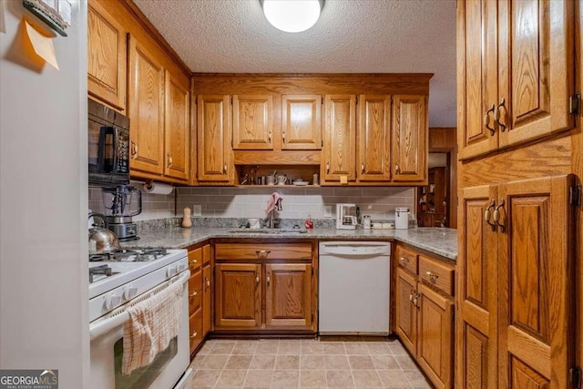 254 E Girard Ave, Cedartown, GA 30125 - kitchen featuring white appliances, brown cabinetry, tasteful backsplash, and a textured ceiling