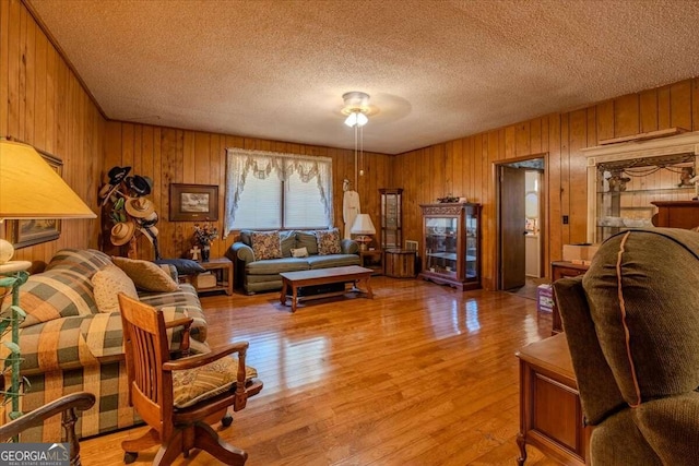 254 E Girard Ave, Cedartown, GA 30125 - living room featuring wooden walls, a textured ceiling, and light wood-style floors