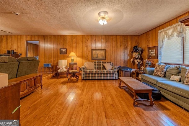 254 E Girard Ave, Cedartown, GA 30125 - living area featuring a textured ceiling, wood finished floors, and wood walls
