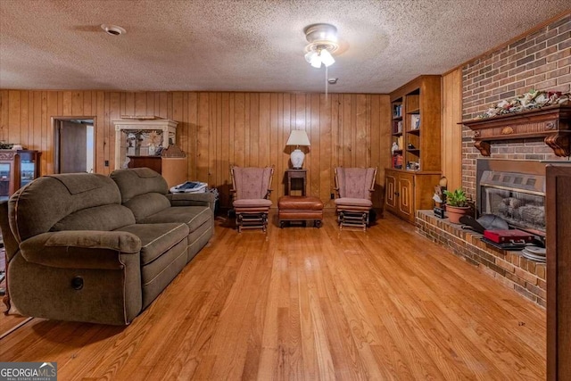254 E Girard Ave, Cedartown, GA 30125 - living room featuring a textured ceiling, wood finished floors, a fireplace, and wood walls