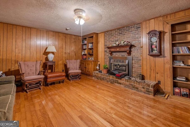 254 E Girard Ave, Cedartown, GA 30125 - living area with wood walls, wood finished floors, a textured ceiling, and built in shelves