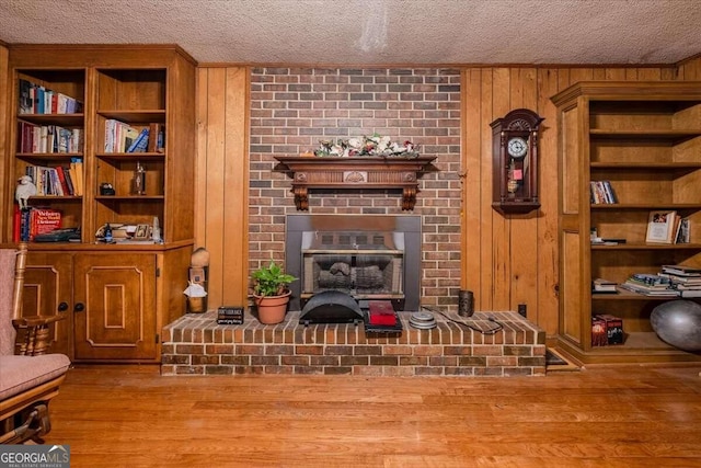 254 E Girard Ave, Cedartown, GA 30125 - living room featuring a textured ceiling, wooden walls, wood finished floors, and built in features