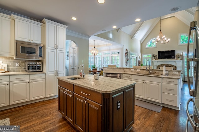 kitchen featuring an inviting chandelier, appliances with stainless steel finishes, and a sink