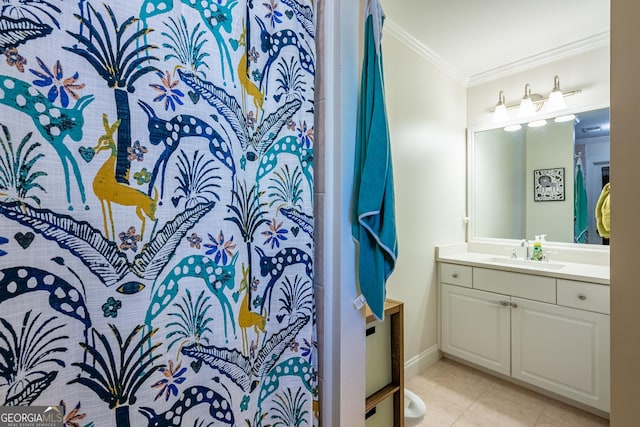 bathroom featuring baseboards, crown molding, vanity, and tile patterned floors
