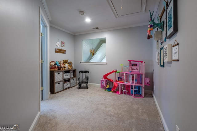 rec room with attic access, ornamental molding, carpet flooring, and visible vents