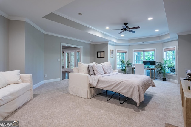 carpeted bedroom featuring baseboards, recessed lighting, ornamental molding, and a raised ceiling